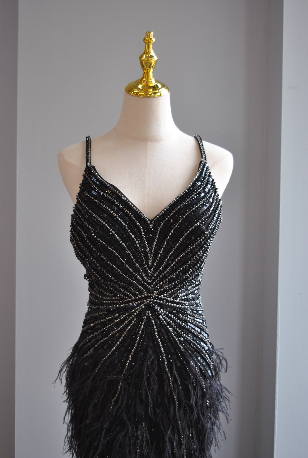 BLACK EVENING GOWN WITH FEATHERS AND RHINESTONES