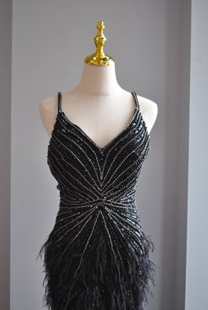BLACK EVENING GOWN WITH FEATHERS AND RHINESTONES