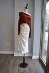 WHITE MIDI SKIRT WITH SIDE RUSHING AND A PIN
