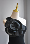 BLACK ASYMMETRIC TOP WITH A FLOWER
