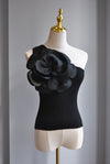 BLACK ASYMMETRIC TOP WITH A FLOWER