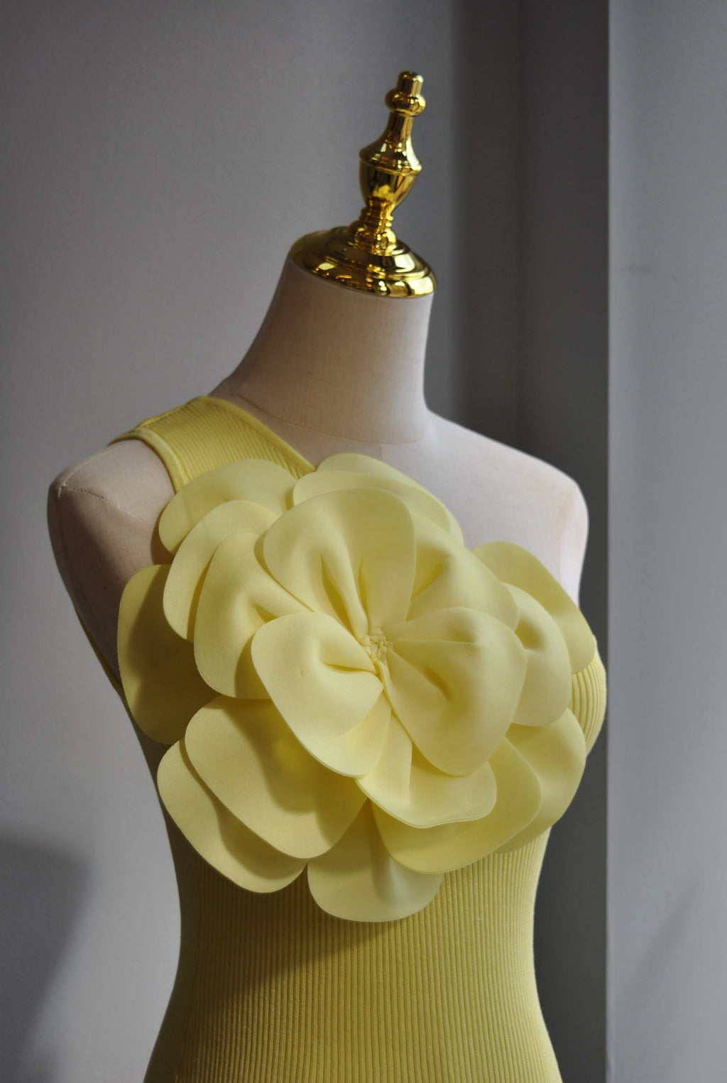 YELLOW ASYMMETRIC TOP WITH A FLOWER