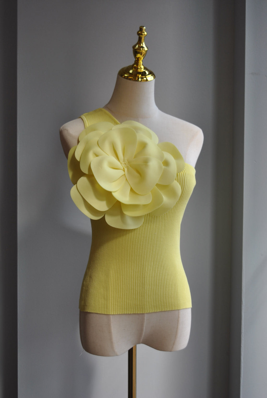 YELLOW ASYMMETRIC TOP WITH A FLOWER