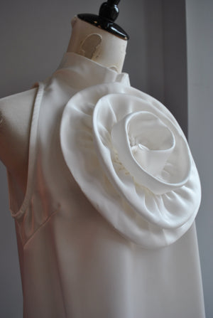 WHITE HALTER STYLE TOP WITH A FLOWER