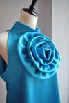 BLUE HALTER STYLE TOP WITH A FLOWER