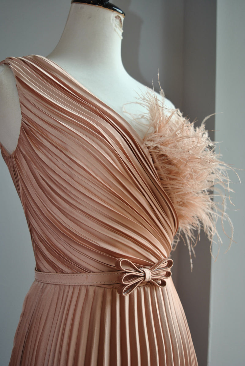 ROSE GOLD PLEATED EVENING GOWN WITH FEATHERS