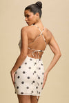 POLKA DOT WHITE AND BLACK MINI SUMMER DRESS WITH A FLOWER AND OPEN BACK