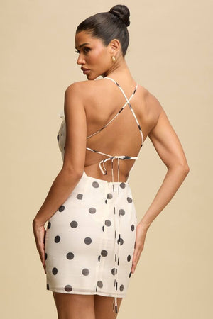 POLKA DOT WHITE AND BLACK MINI SUMMER DRESS WITH A FLOWER AND OPEN BACK