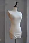 WHITE BODYSUIT WITH STATEMENT SHOULDER